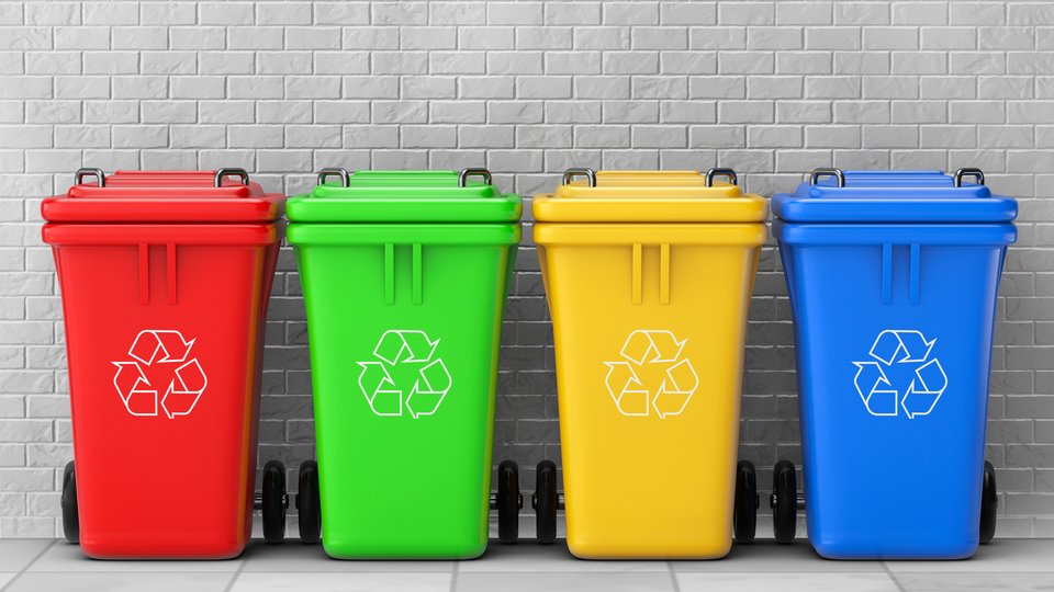The image shows trash bins in different colors.
