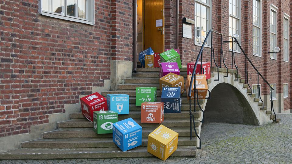The IVL office entrance and staircase full of card board cubes with the sustainable goals printed on them