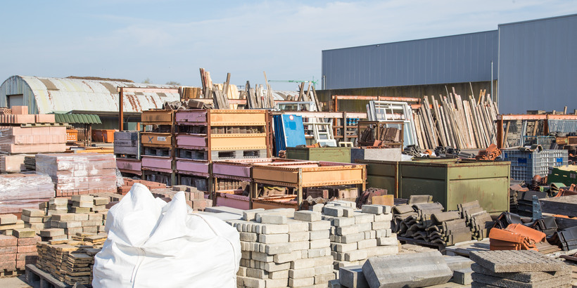 Many piles of different reusable building materials from old houses and buildings. 
