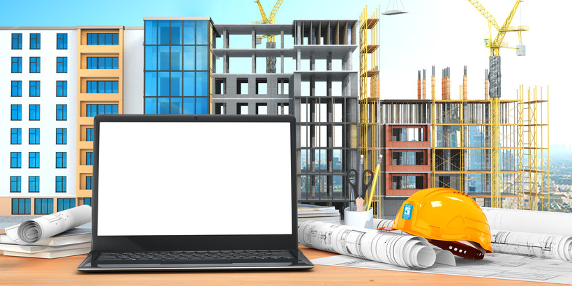 Desktop with an open laptop, construction drawings in rolls, construction helmet on the background of construction. 3D illustration
